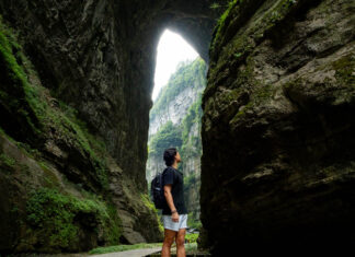 Person looking at the Three Natural Bridges at Wulong Karst