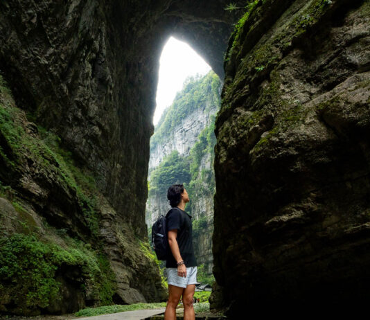 Person looking at the Three Natural Bridges at Wulong Karst