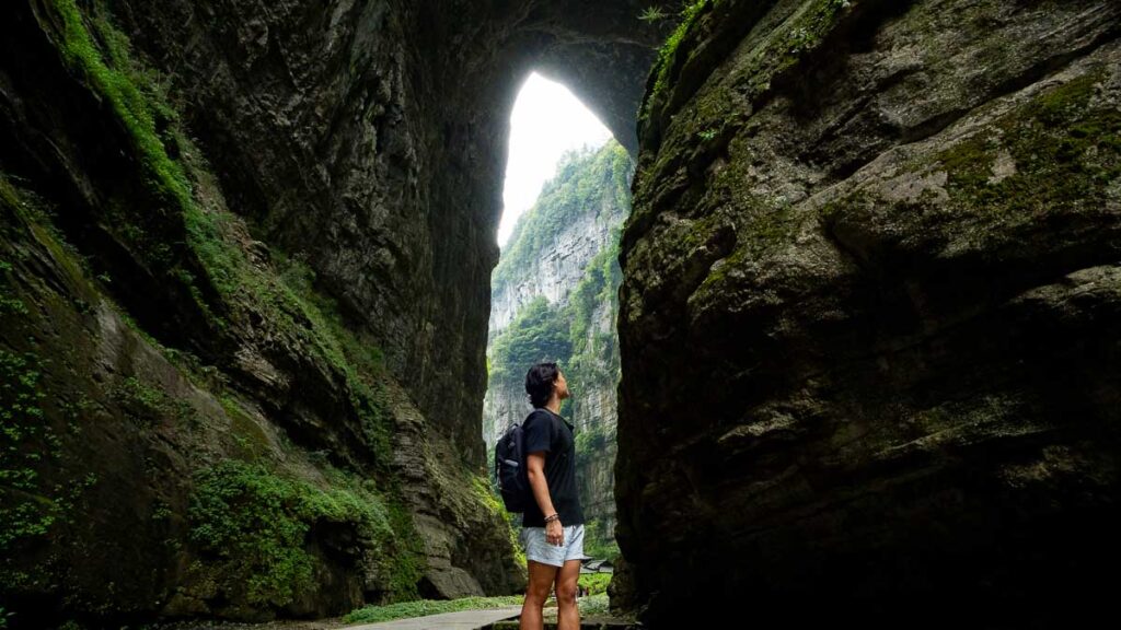 Person in front of the magnificent Tianlong Bridge of the Three Natural Bridges, Wulong Karst