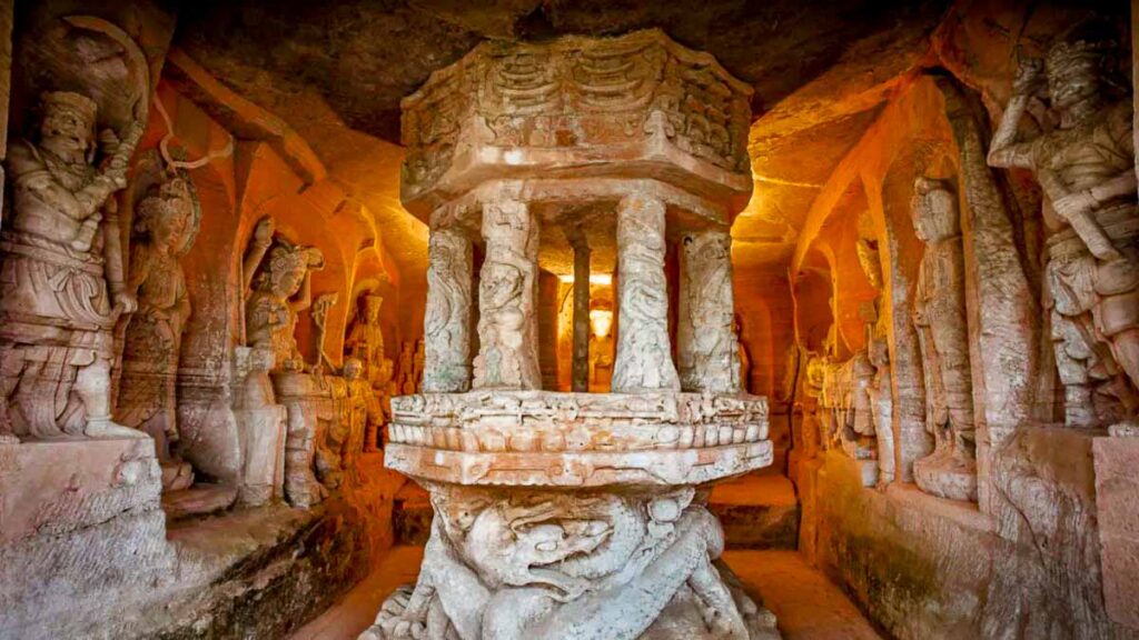 Carvings inside a honeycomb-like nook at Beishan, Dazu Rock Carvings