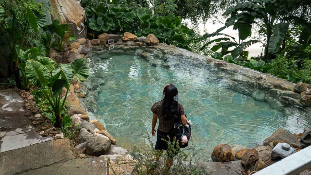 Person looking out into a hot spring area at Jingangbei Ancient Village