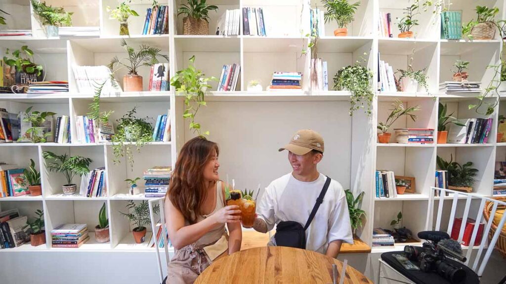 (2 people sitting in a cafe) - (best HCMC cafes)