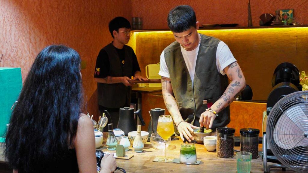barista making a drink - Best HCMC Cafes