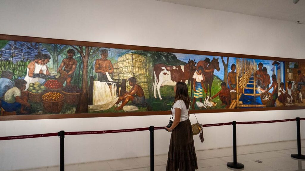 Girl looking at a painting in the National Museum of the Philippines - Things to do in Davao