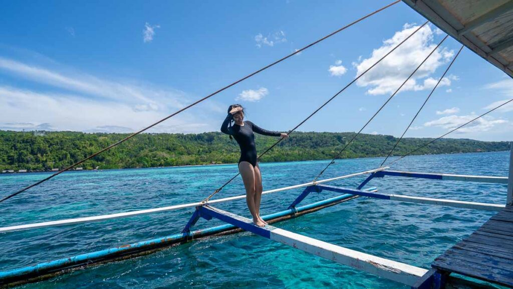 Girl on a small boat while island hopping in Samal Island - Davao Guide