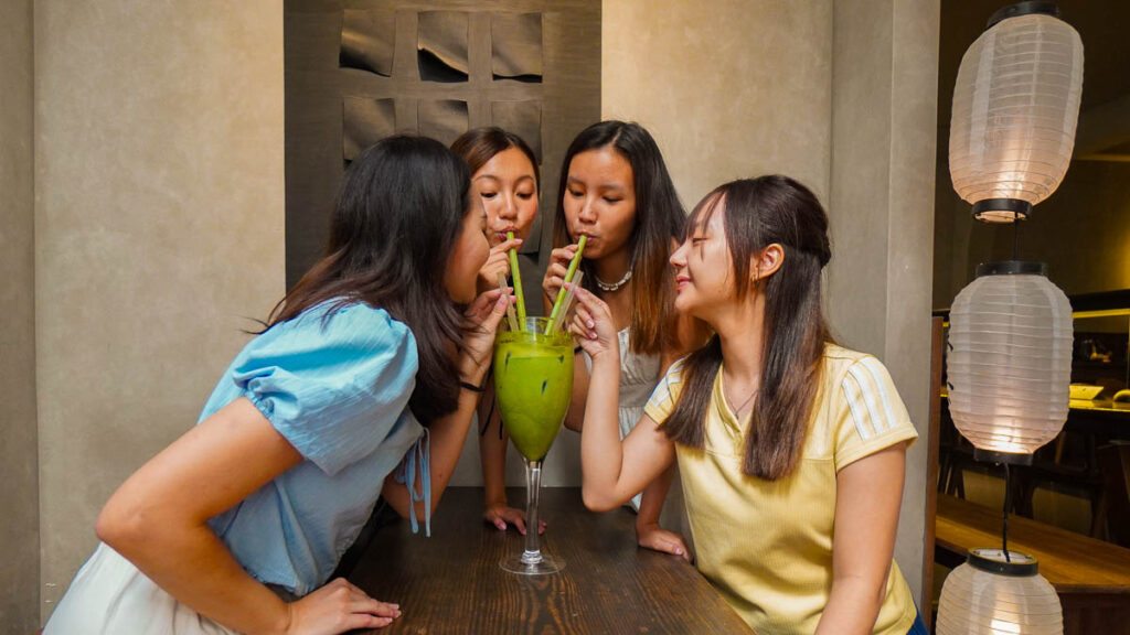 Girls drinking big matcha - Things to do in Ho Chi Minh City