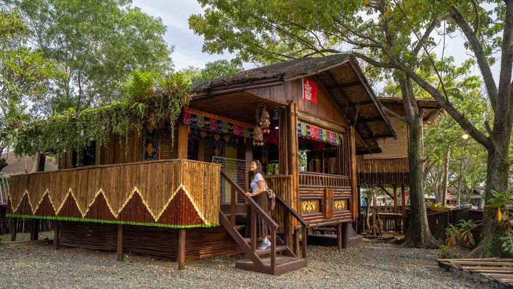 Girl entering a hut in Magsaysay Park - Things to do in Davao