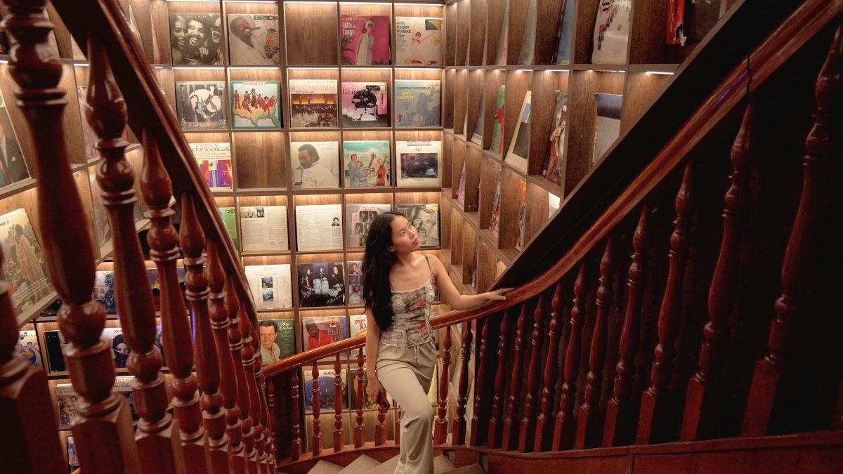 Girl walking on Ngam Cafe staircase - Cafes in Ho Chi Minh City