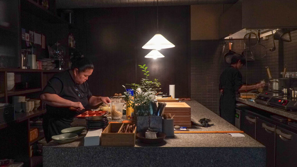 Chef cooking in dimly lit kitchen - Hidden places in Singapore