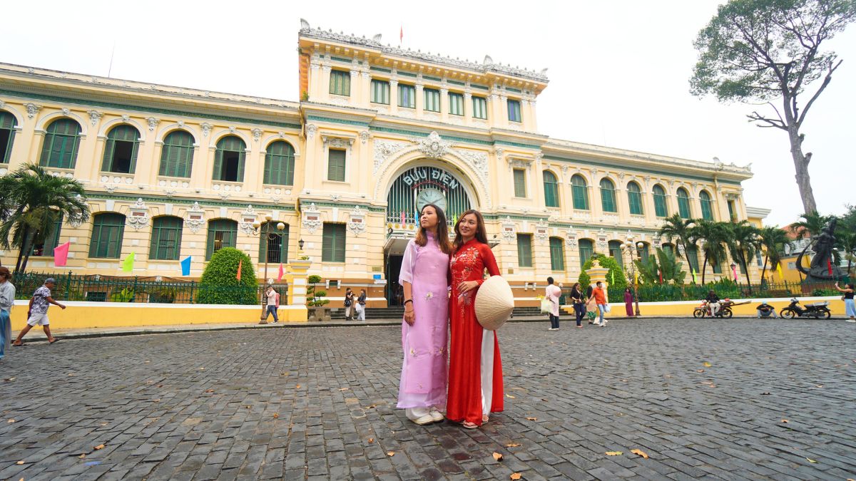 Two girls posing in front of Saigon Central Post Office - Things to Do in Ho Chi Minh City