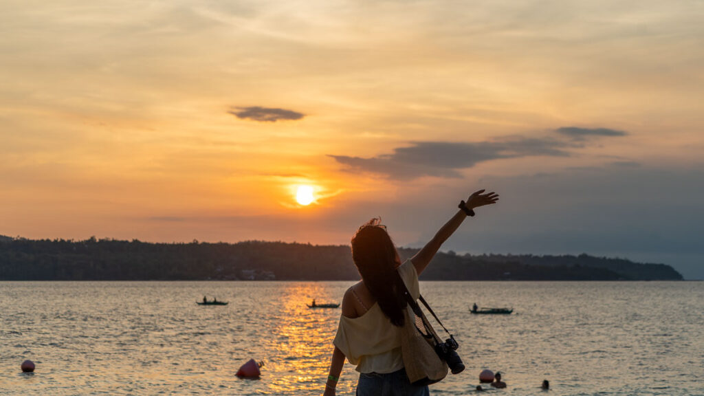 Girl admiring the sunset from Kaputian Beach in Samal Island - Davao Guide