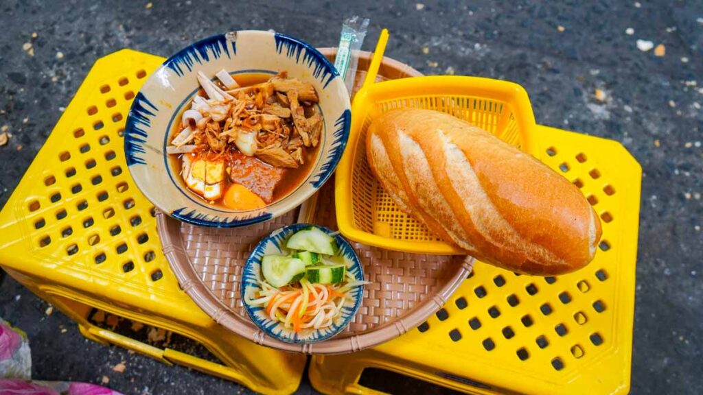 Banh mi cham and banh mi on yellow stools - Ho Chi Minh City Things to Do