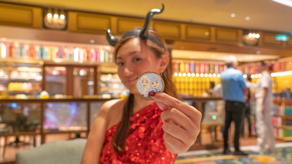 Girl Holding onto Disney Pin - Things to Do on Disney Adventure