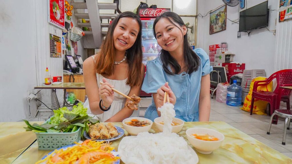 Girls eating bun cha - Ho Chi Minh City Things to Do