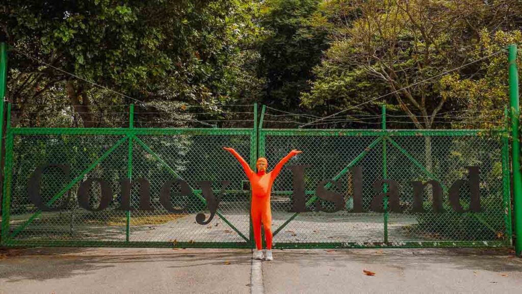 A man standing in front of a park gate - things to do in punggol