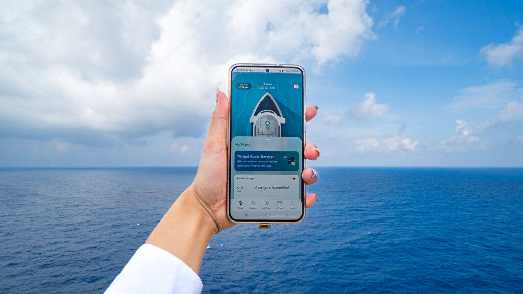 Hand Holding the Disney Cruise Line Navigator App - Disney Cruise Singapore Tips