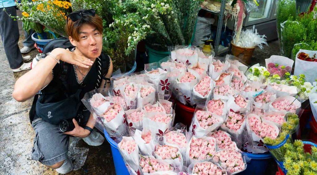 man standing with a bunch of flowers - Ho Chi Minh City Budget Itinerary