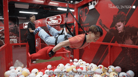 man hanging on claw machine