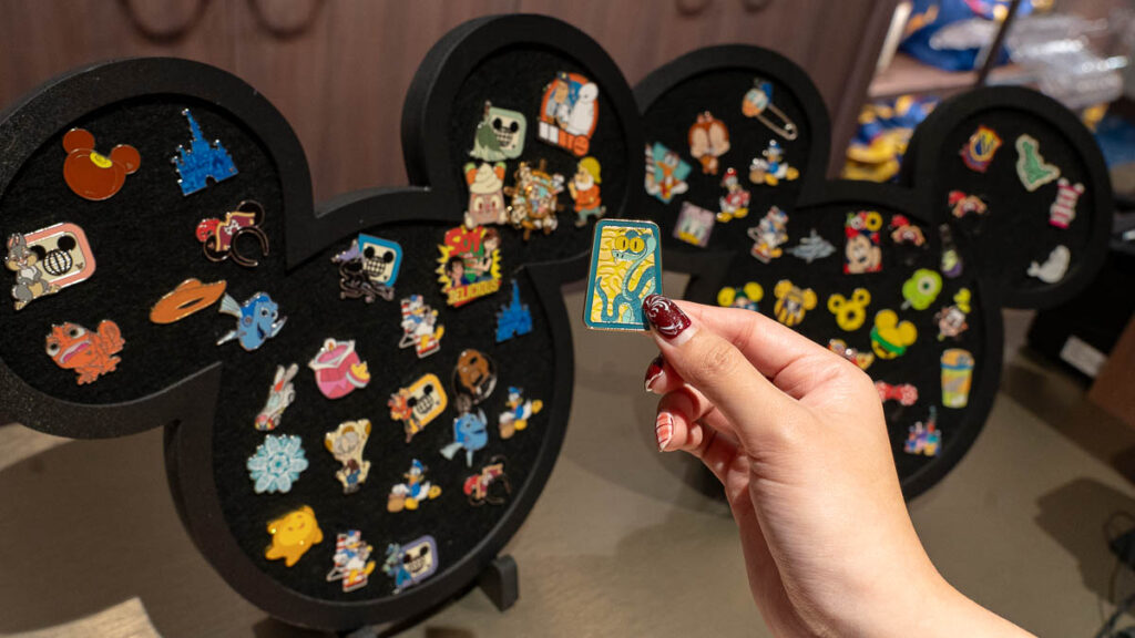 Hand Holding Onto a Pin for Trading - Disney Cruise Singapore Tips