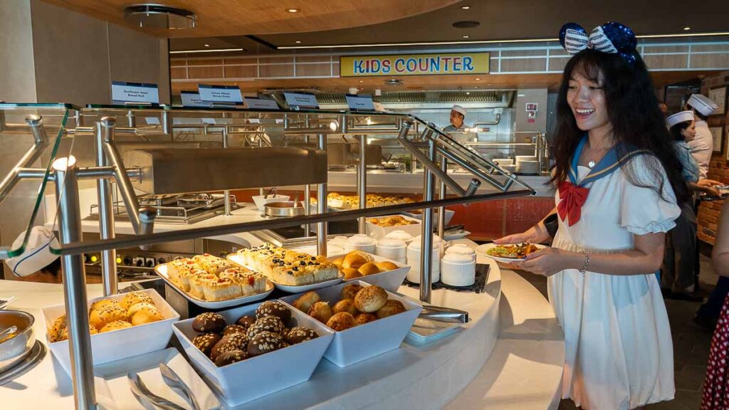 Girl at Pixar Market Restaurant Buffet - Disney Cruise Singapore Tips