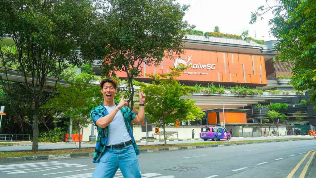 man standing in front of a sports centre - things to do in punggol