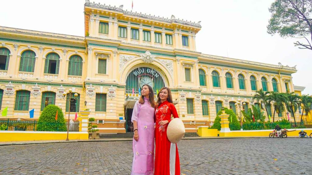 Girl in ao dai in front of Saigon Central Post Office - Ho Chi Minh City Things to Do