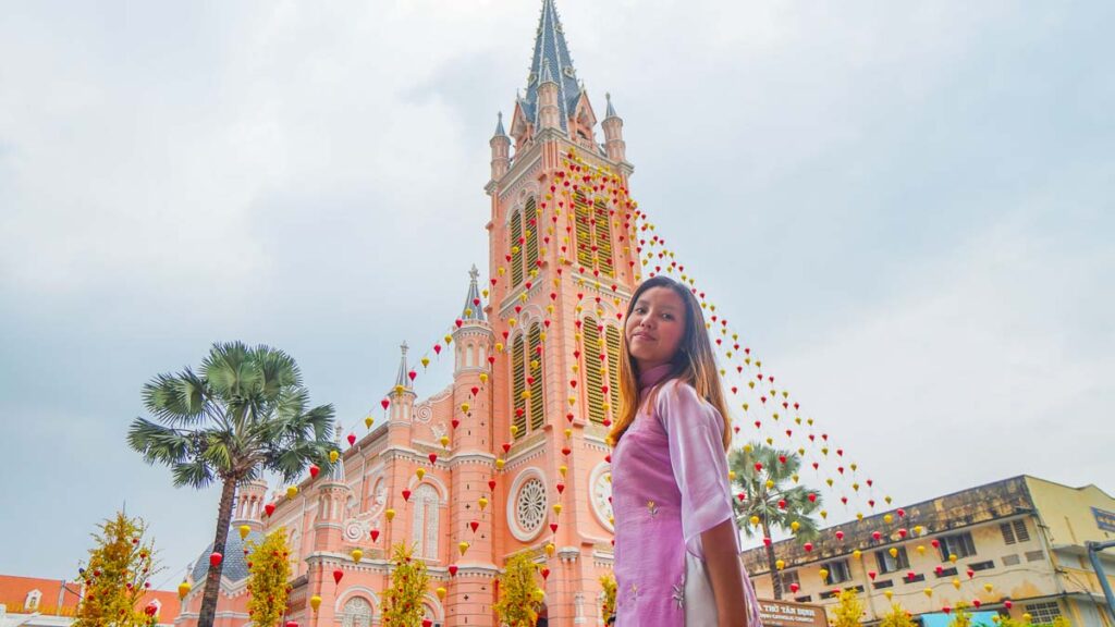 Girl in ao dai in front of pink church - Ho Chi Minh City Things to Do