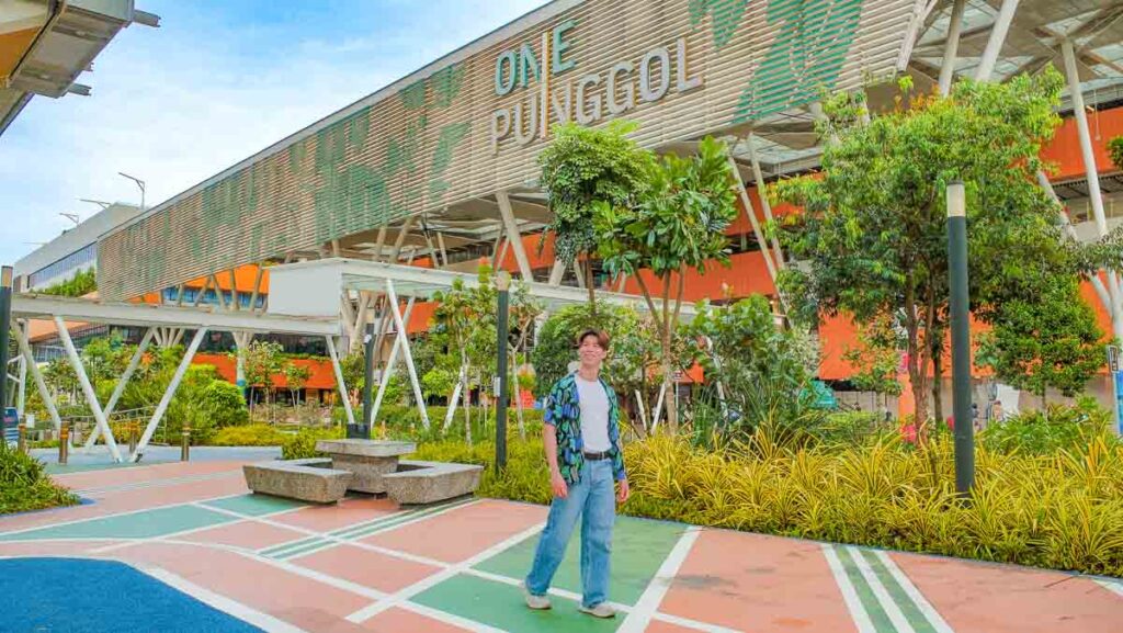 A Man walking around a building - things to do in punggol