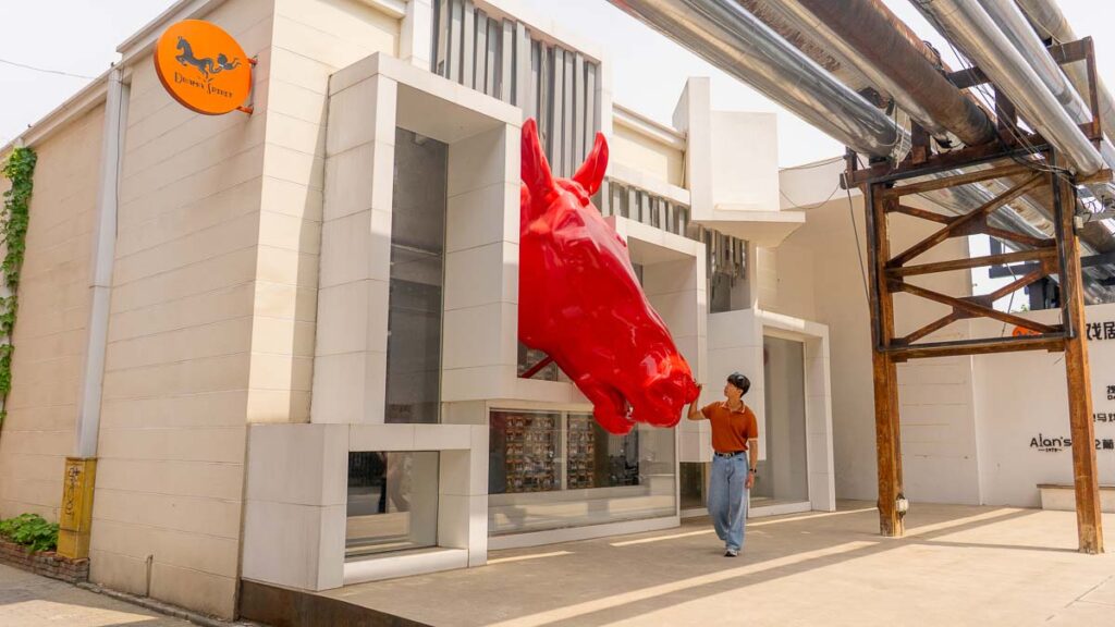 Man standing in front of horse piece - Beijing Itinerary