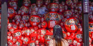 Girl looking at Darumas - Lesser-known things to do in Osaka