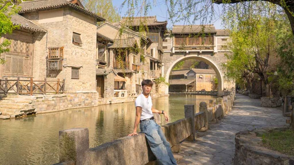 Man standing along Gubei Watertown Scenery Along Riverside - Beijing Itinerary