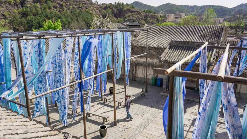 Man walking along a Dye House - Beijing Itinerary