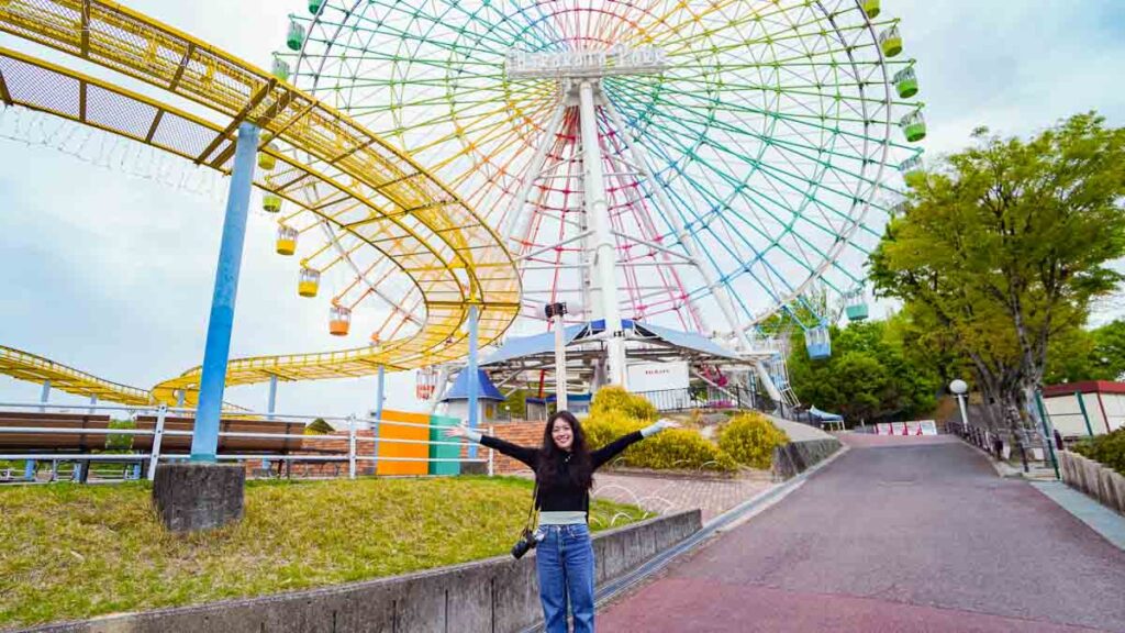 Girl with hands up at theme park - Lesser-known things to do in Osaka