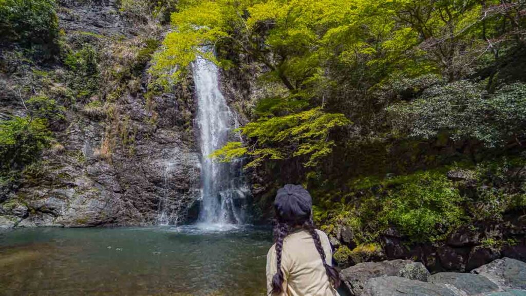 Girl looking at waterfall - Lesser-known things to do in Osaka