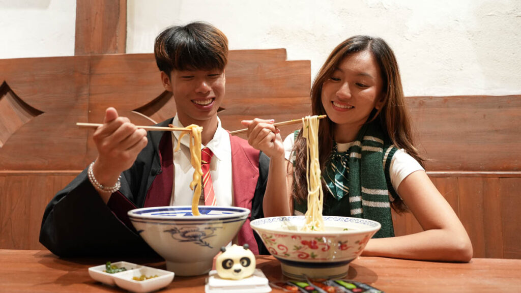 Two people eating Noodles - Beijing Itinerary
