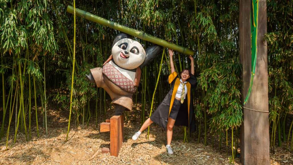 Girl hanging on a Kungfu Panda - Universal Studio Beijing Guide