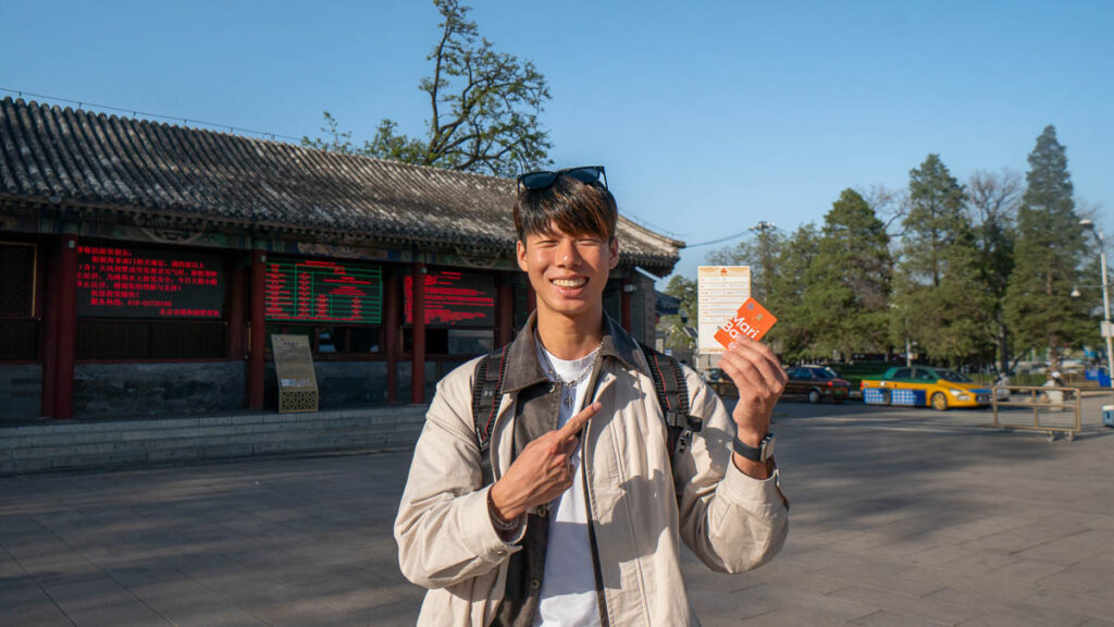man Holidng onto a credit Card - Beijing Itinerary