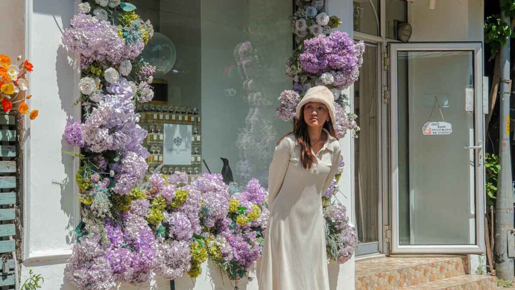 Lady posing in front of flower Storefront - Beijing Itinerary