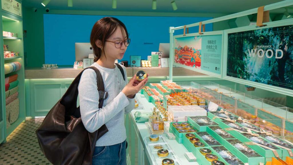 Girl looking at handcreams in store - Beijing Itinerary