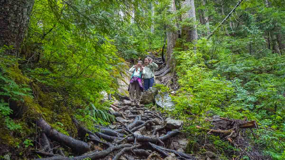 Girls at the top of tree roots - Vancouver day trips