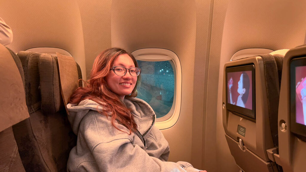 Girl at airplane window seat - Vancouver Guide