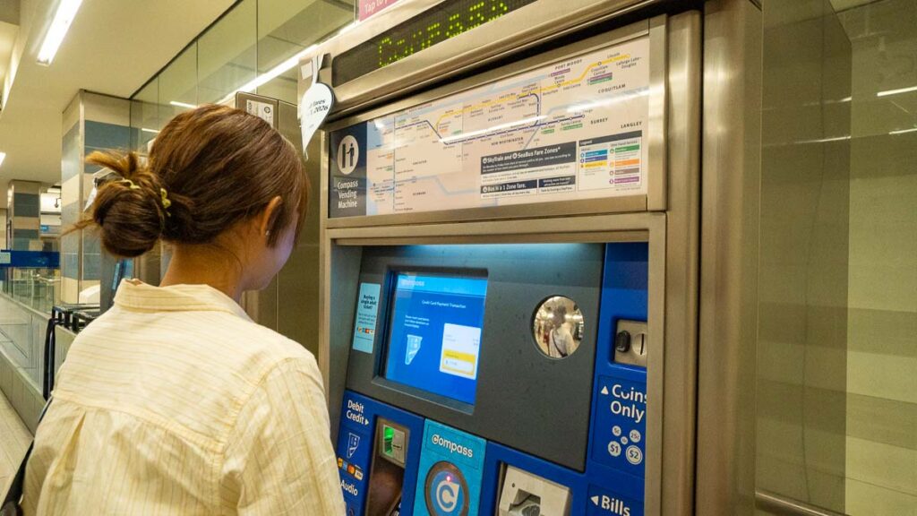 Girl at Train Ticketing Machine - Things to do in Vancouver
