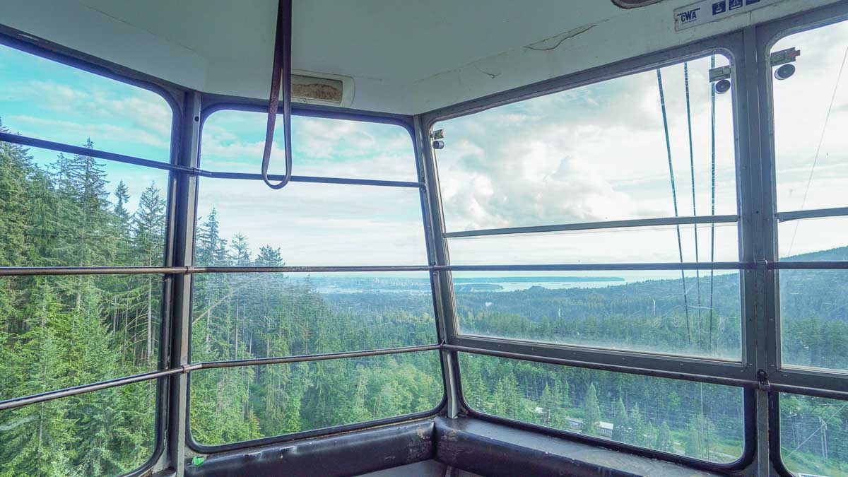 Gondola with views of trees and city - First-timers in Vancouver