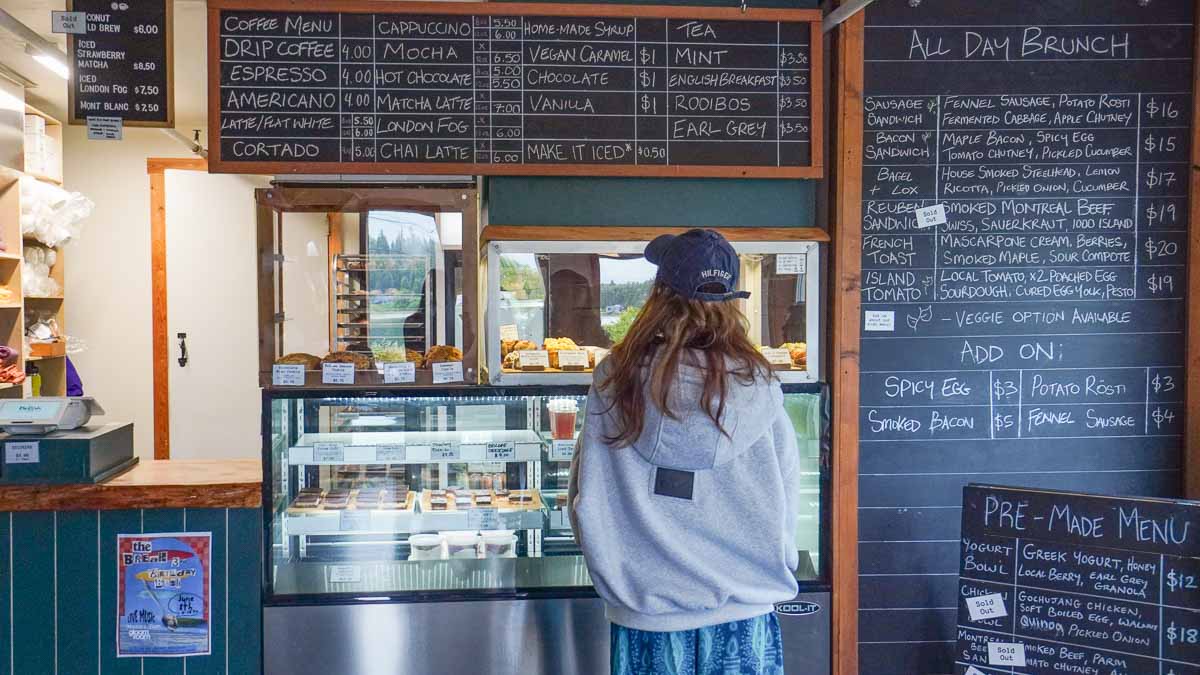 Girl looking at cafe menu - Vancouver travel tips
