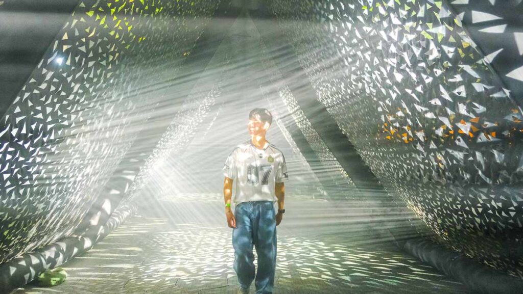 Man walking through light exhibit - Things to do in Singapore June