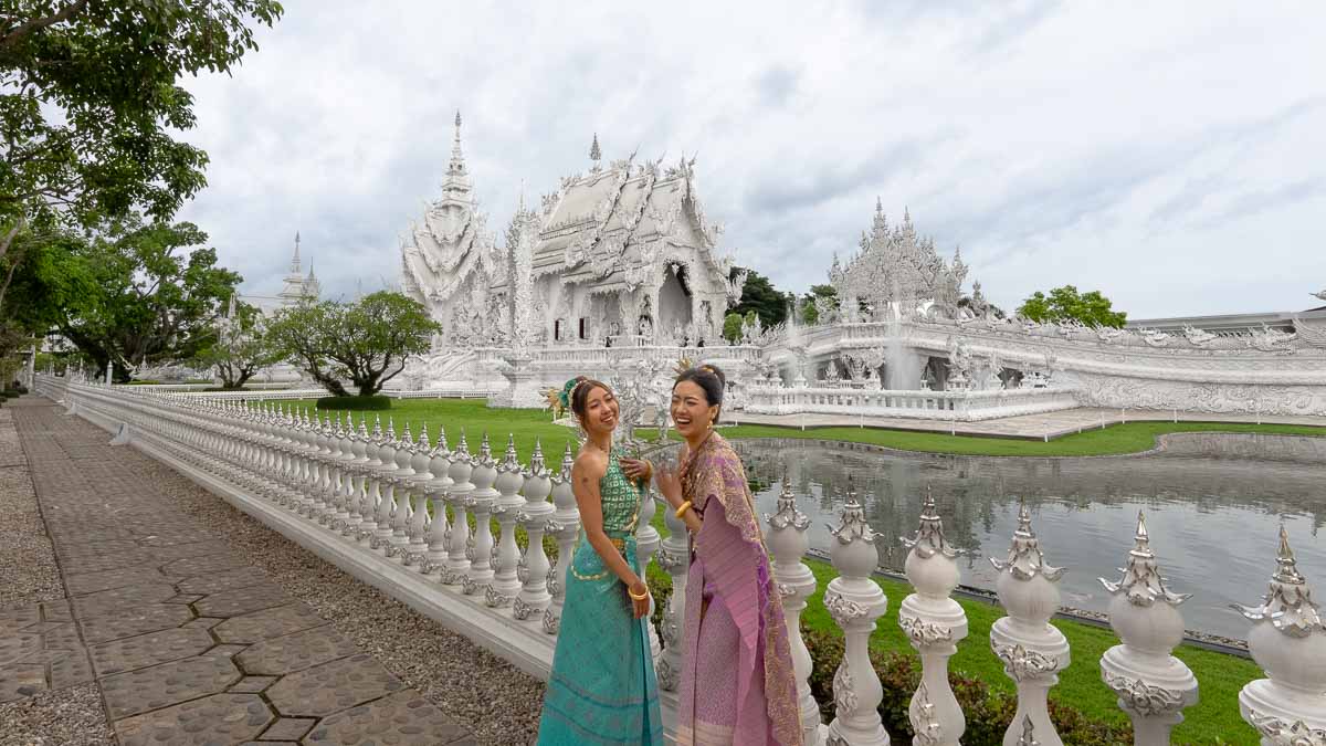 Girls laughing at teh White Temple in Chiang Rai - Things to do in Chiang Rai