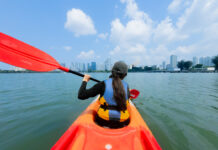Kallang Neighbourhood Guide — A Low-key 1-Day Itinerary For Your Next Offline Day Girl Kayaking in Kallang - Kallang Neighbourhood Guide