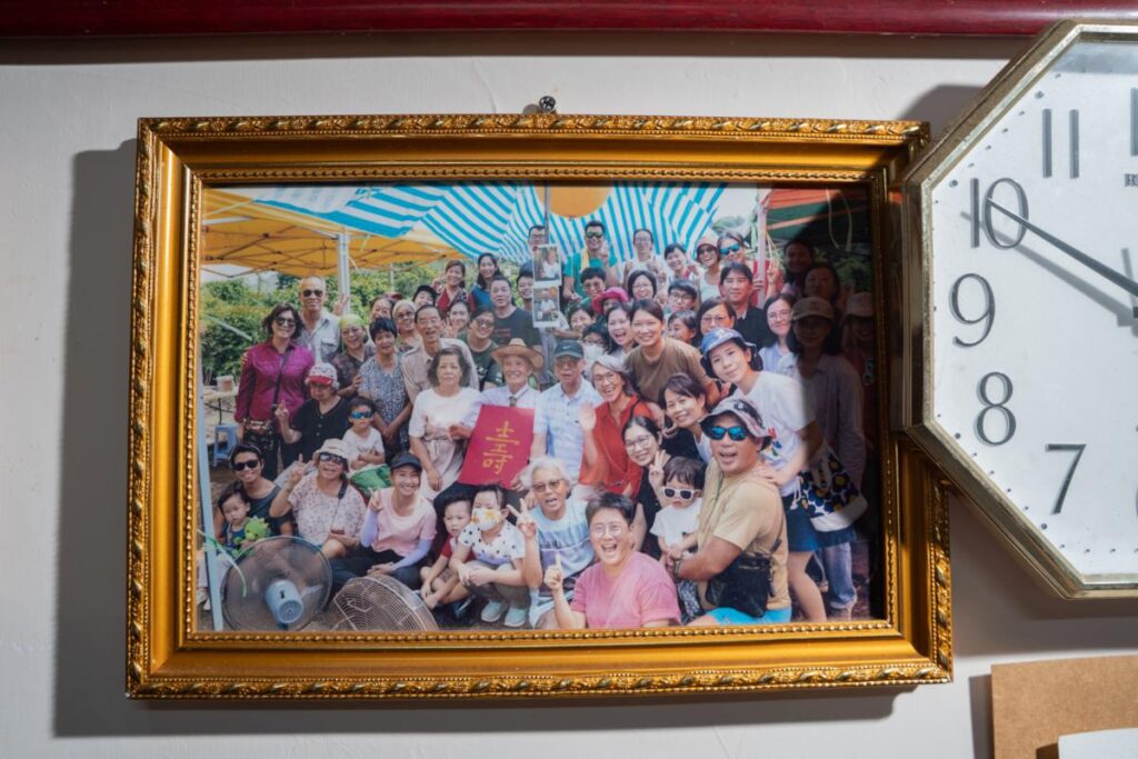A framed photograph of Kiang Wong’s 100th birthday celebration in 2021 - RURAL ROOTS (NTU GO-FAR 2026)