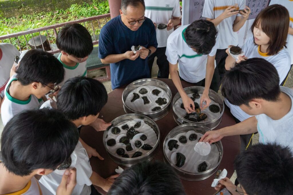 A school group feasting on traditional Hakka tea cakes on an educational tour - RURAL ROOTS (NTU GO-FAR 2026)