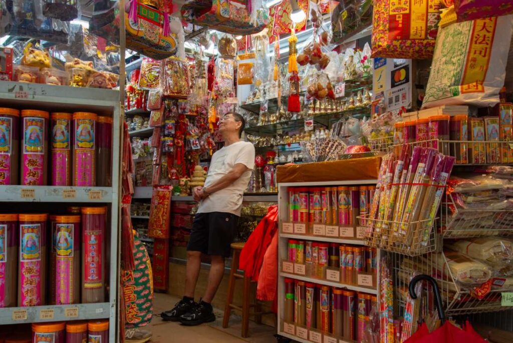 A shopowner and his burnable offerings shop along the streets of Sai Wan - RITUALS (NTU GO-FAR 2026)